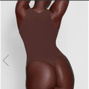 SKIMS Sculpting Bodysuit —
Size M (Buttery Soft
neutral brown shade.